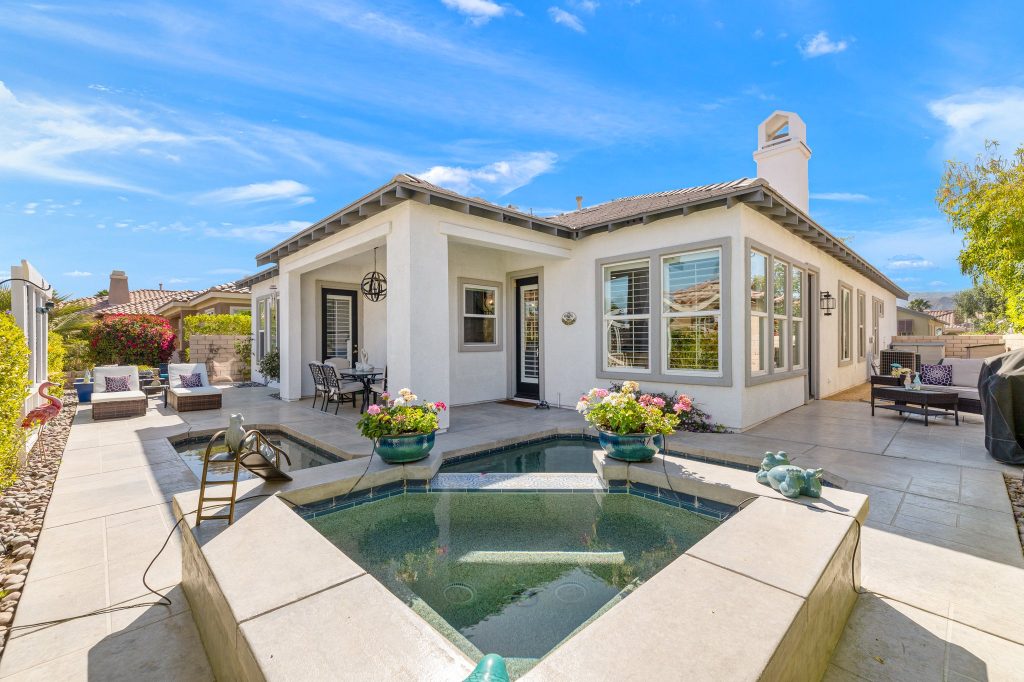 Rear exterior of 4 Lake Como Ct in Rancho Mirage, showing the spa and patio.